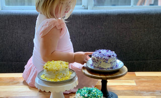 Kids Cake Boxes. Cake kits for virtual parties and virtual gatherings. Picture of young girl with pretty personal-sized cakes provided by Kids Cake Boxes